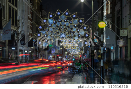 Christmas crowns decoration led lights display. Dramatic view of the traditional Christmas decoration lights hanging above Bond street during dusk. Christmas crowns decoration led lights display. Dramatic view of the traditional Christmas decoration lights hanging above Bond street during dusk. 110316216