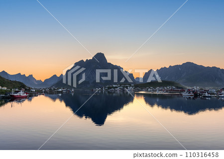 Serene fjord reflects rugged peaks as a Lofoten village awakens to sunrise hues Serene fjord reflects rugged peaks as a Lofoten village awakens to sunrise hues 110316458