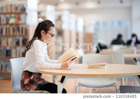 A girl reading a book A girl reading a book 110316485