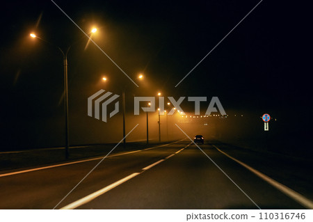 Night road in fog with yellow lanterns 110316746