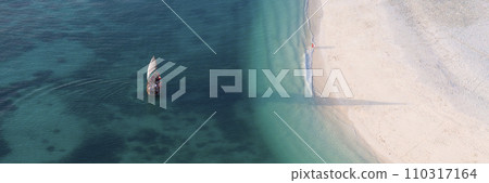 high angle view of tourist boat in the green ocean and white sandy beach 110317164