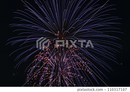 The glow of fireworks adds color to the summer night sky 110317187