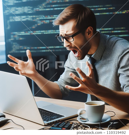 Emotional programmer expressively works at a laptop Emotional programmer expressively works at a laptop 110319492