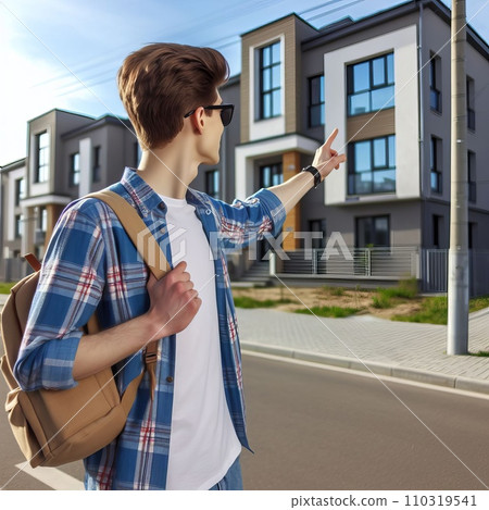 The young man joyfully points to his house The young man joyfully points to his house 110319541