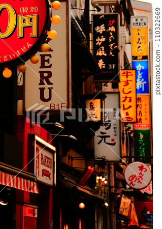 Downtown signboard at dusk: Image of a downtown area lined with restaurants Downtown signboard at dusk: Image of a downtown area lined with restaurants 110322669