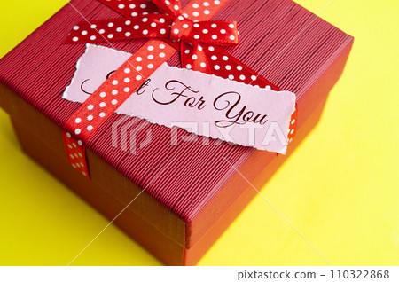 Just for you text on torn paper on top of present on red background 110322868