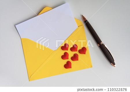 Top view of blank envelope with heart shape on white cover. Valentine's day concept 110322876