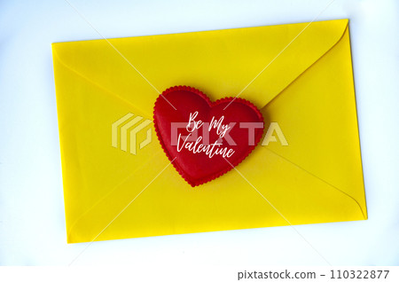 Be my Valentine text on heart shape on yellow paper envelope. Love concept 110322877