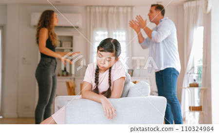 Young girl trapped in the middle of tension by her parent argument. Synchronos 110324984