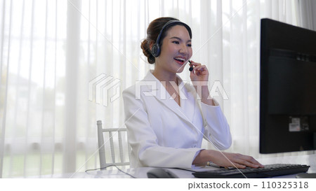 Businesswoman wearing headset working in vivancy office 110325318