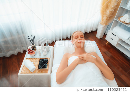 Caucasian woman customer enjoying relaxing anti-stress massage. Quiescent 110325431