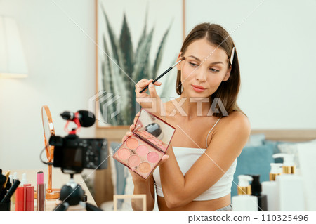 Young woman making beauty and cosmetic tutorial video content. Unveiling Young woman making beauty and cosmetic tutorial video content. Unveiling 110325496