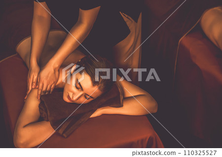 Caucasian woman customer enjoying relaxing anti-stress massage. Quiescent 110325527