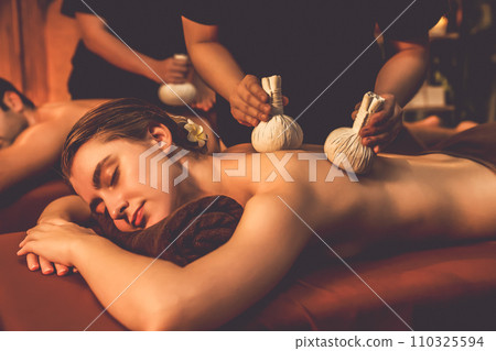 Hot herbal ball spa massage body treatment with couple customer. Quiescent Hot herbal ball spa massage body treatment with couple customer. Quiescent 110325594