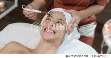 Beautiful caucasian woman having facial massage at spa. Close up. Tranquility 110325638
