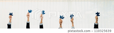 Panorama banner of business team assembling jigsaw puzzle. Shrewd 110325639