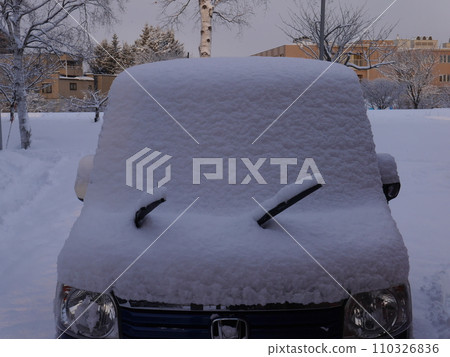 A car covered in snow 110326836