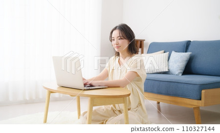 Young woman using a personal computer Young woman using a personal computer 110327144