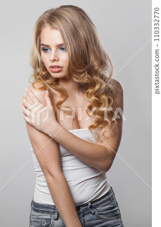 Charming lady with curly hairdo standing on white background. Beauty woman portrait 110332770
