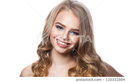 Female face with cute smile. Blonde woman with long curly hair and makeup studio portrait 110332804