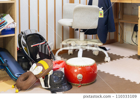 School bag, drum, keyboard harmonica in the child's room 110333109