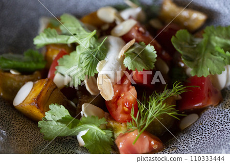 Vegetarian Eggplant Salad with Baked Aubergine, Cherry Tomatoes and Cilantro Close Up. Macro Photo of Grilled Eggplants and Cottage Cheese with Fresh Dill, Parsley, Sesame Seeds and Spicy Oil Vegetarian Eggplant Salad with Baked Aubergine, Cherry Tomatoes and Cilantro Close Up. Macro Photo of Grilled Eggplants and Cottage Cheese with Fresh Dill, Parsley, Sesame Seeds and Spicy Oil 110333444