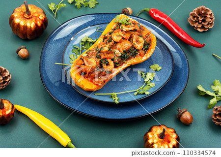Baked pumpkin stuffed with vegetables and shrimp. 110334574