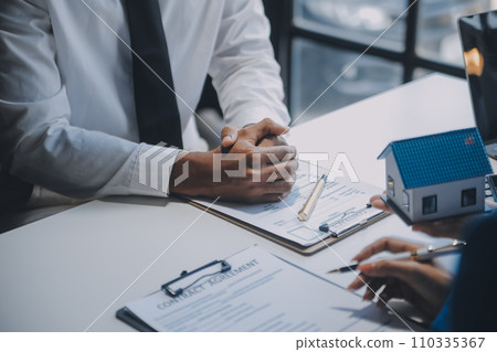 Real estate agent and customer signing contract to buy house, insurance or loan real estate.rent a house,get insurance or loan real estate or property. Real estate agent and customer signing contract to buy house, insurance or loan real estate.rent a house,get insurance or loan real estate or property. 110335367