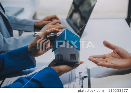 Real estate agent and customer signing contract to buy house, insurance or loan real estate.rent a house,get insurance or loan real estate or property. Real estate agent and customer signing contract to buy house, insurance or loan real estate.rent a house,get insurance or loan real estate or property. 110335377