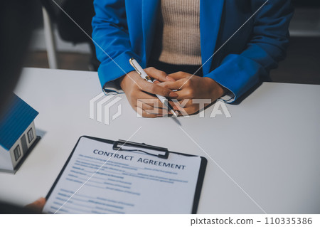 Real estate agent and customer signing contract to buy house, insurance or loan real estate.rent a house,get insurance or loan real estate or property. 110335386