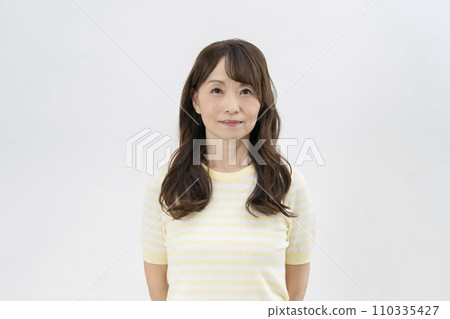 Portrait of a woman in her mid-50s smiling at the camera, white background Portrait of a woman in her mid-50s smiling at the camera, white background 110335427