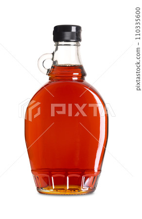 Maple syrup in a glass bottle. Bottled Canadian maple syrup made from the sap of maple trees in which sucrose is the most prevalent sugar. Used in baking, as condiment, sweetener and flavouring agent. 110335600