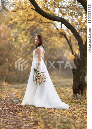 beautiful happy bride holding wedding autumn bouquet in nature 110335818