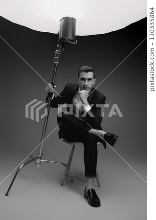 elegant model man in black suit in photostudio. black and white 110335864