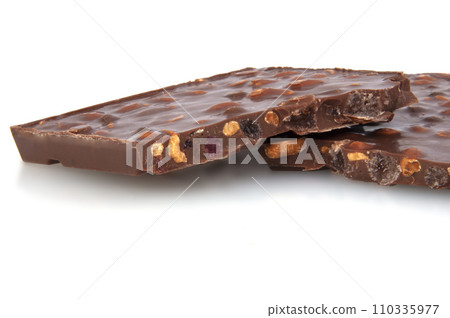 milk chocolate with nuts and berries brocken isolated on the white 110335977