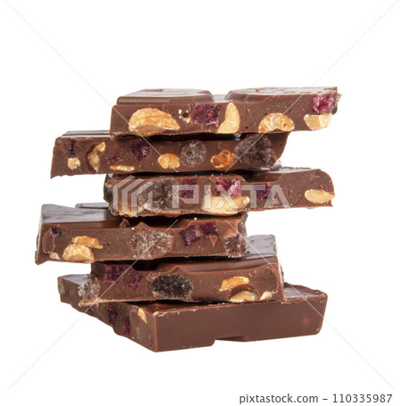 milk chocolate with nuts and berries brocken isolated on the white 110335987