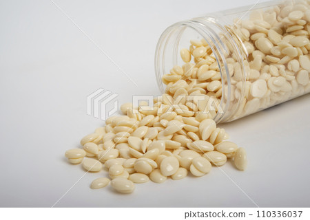 spa wax for depilation in granular form on the white background spa wax for depilation in granular form on the white background 110336037