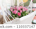 Bouquet of beautiful pink tulips in white hammock. Mother's and International Women's Day, Valentine's day, concept. Gift for Birthday celebration. Bright sun rays. Greeting card. Copy space for text 110337147