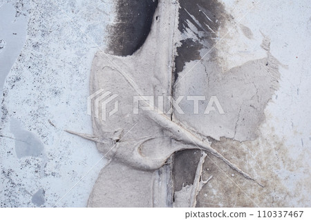 Dusty peeling paint on a wall background, texture of a concrete old wall with stains and cracks 110337467