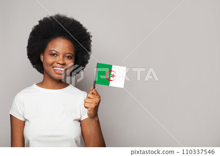 Algerian woman holding flag of Algeria Education, business, citizenship and patriotism concept Algerian woman holding flag of Algeria Education, business, citizenship and patriotism concept 110337546