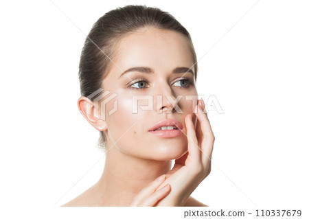 Attractive woman touching her flawless glowy fresh clean facial skin, portrait. Healthcare, wellness 110337679