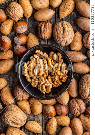 Peeled dried walnut kernels in bowl. Top view. Peeled dried walnut kernels in bowl. Top view. 110337753