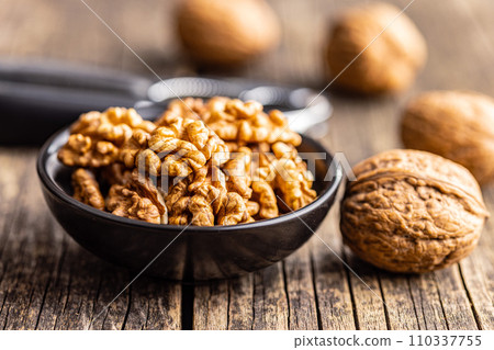 Peeled dried walnut kernels in bowl. 110337755