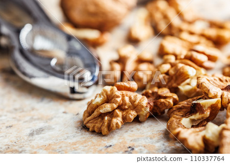 Peeled dried walnut kernels on kitchen table. Peeled dried walnut kernels on kitchen table. 110337764