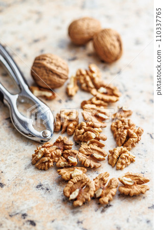Peeled dried walnut kernels on kitchen table. Peeled dried walnut kernels on kitchen table. 110337765