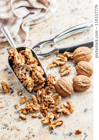 Peeled dried walnut kernels in scoop. Peeled dried walnut kernels in scoop. 110337776