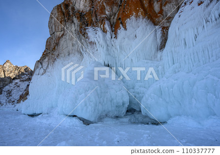 Cape Three Brothers. Beautiful winter landscape of frozen Baikal Lake. Cape Three Brothers. Beautiful winter landscape of frozen Baikal Lake. 110337777