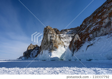 Cape Three Brothers. Beautiful winter landscape of frozen Baikal Lake. Cape Three Brothers. Beautiful winter landscape of frozen Baikal Lake. 110337792