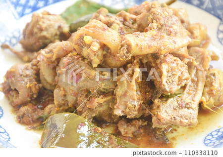 spicy fried chop chicken bone with basil in chili curry sauce on plate spicy fried chop chicken bone with basil in chili curry sauce on plate 110338110