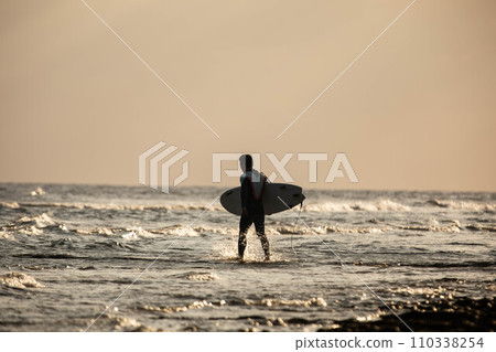 Surfer surfing in the sea of Okinawa 110338254